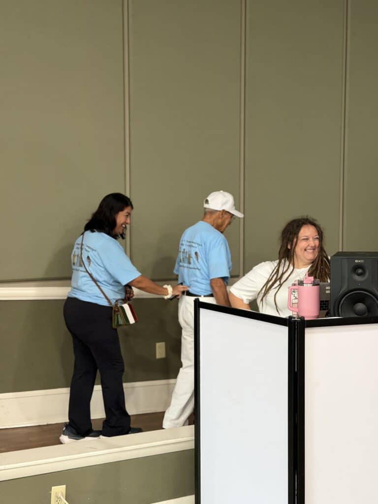 Volunteers standing beside a sound booth at the event