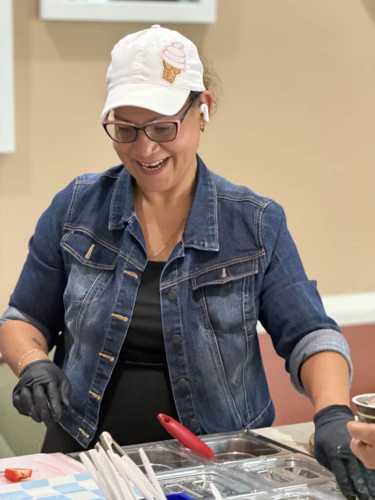 Woman in a white cap and denim jacket preparing food